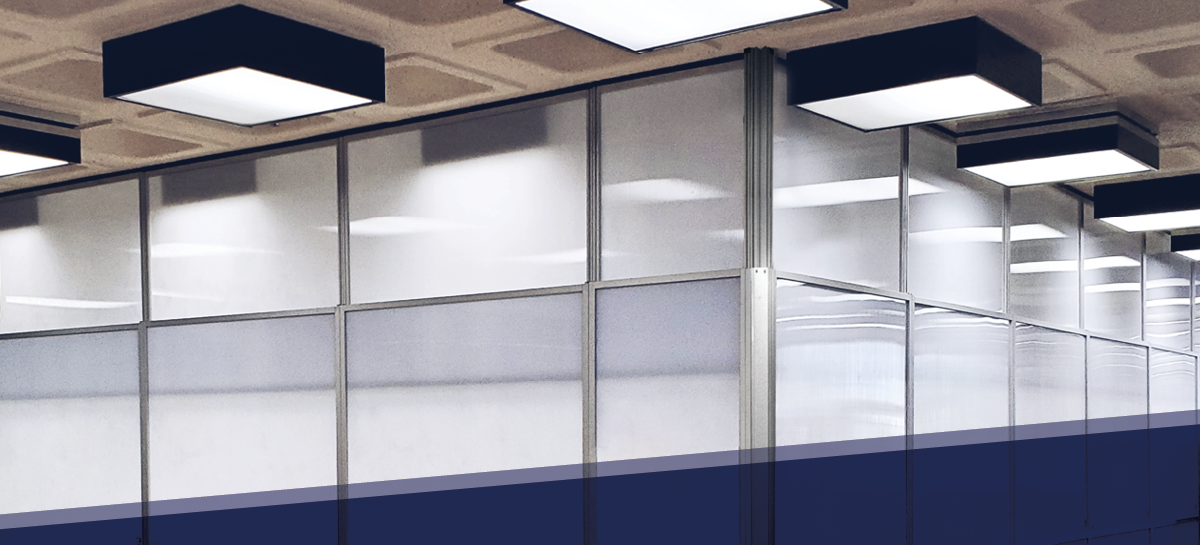 Modular containment wall system with translucent panels and overhead lighting in a commercial or healthcare renovation setting.          Ask ChatGPT