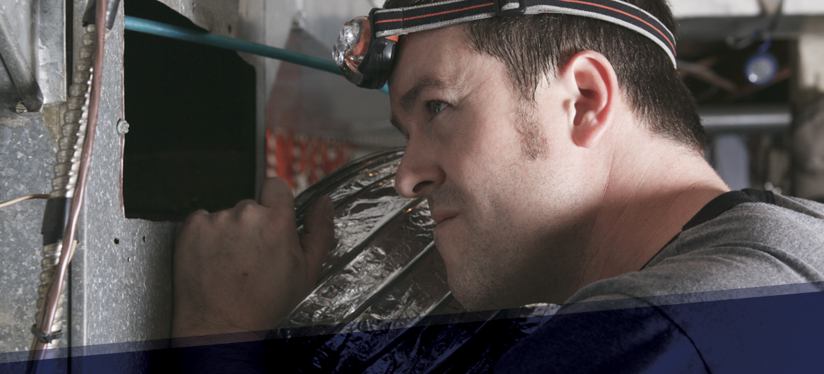 HVAC technician inspecting ductwork with a headlamp during a residential ventilation system check. Focused on identifying air leaks, blockages, and maintenance needs to improve airflow and energy efficiency.